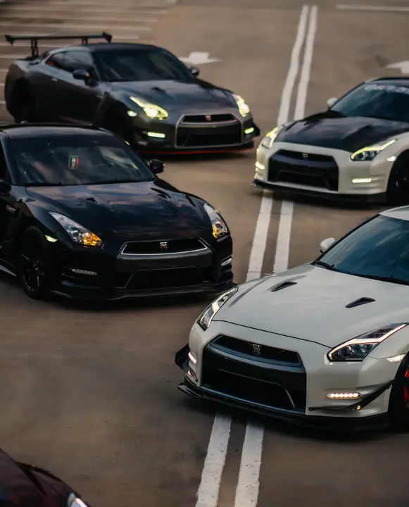 Three sports cars parked nose to nose