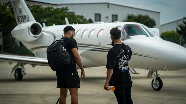 Crew boarding a private jet on the tarmac