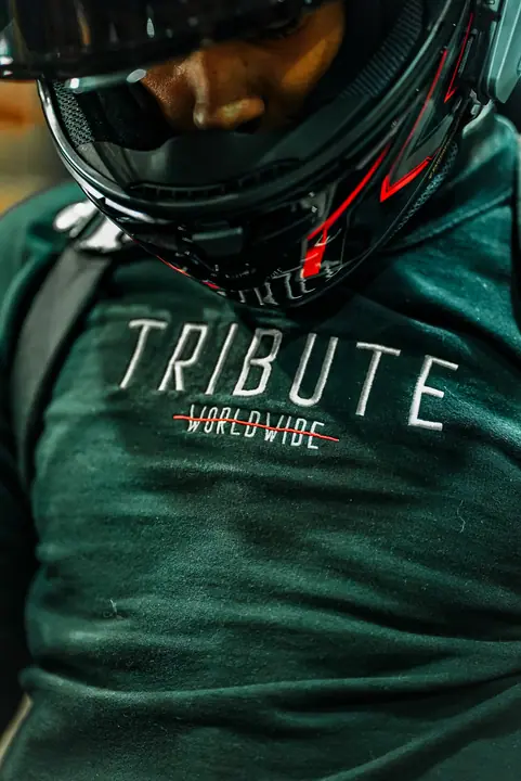 Motorcycle rider in a branded jersey