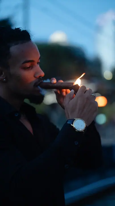 Lighting a cigar at dusk