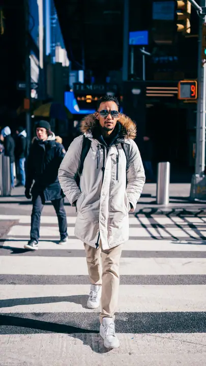 Model crossing a city street in winter