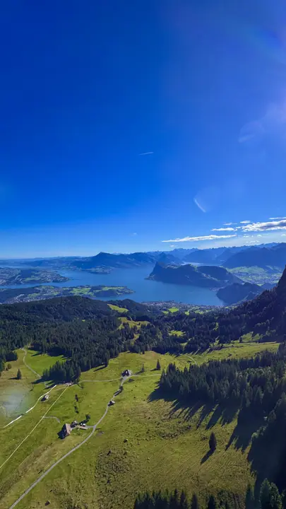 Lake and green hills seen from a mountain