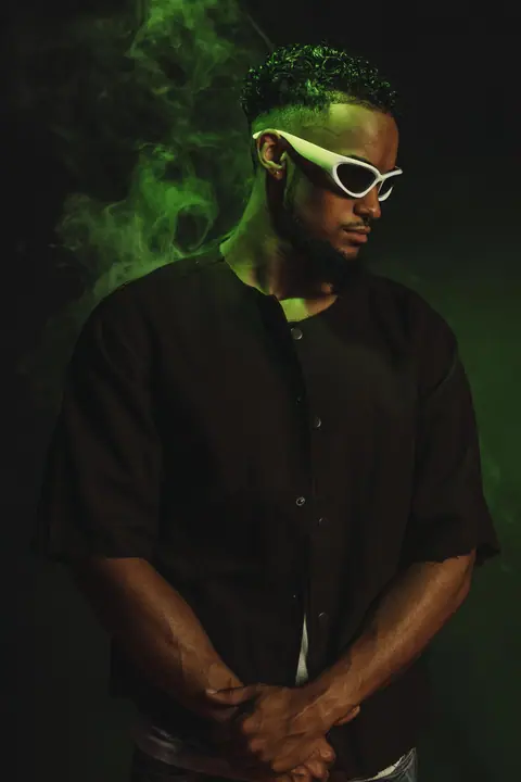 Portrait in sunglasses with green backlight