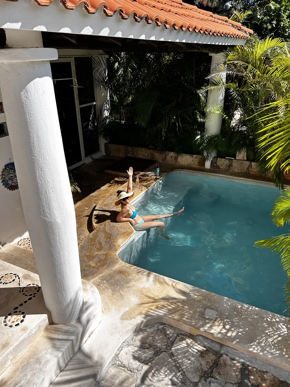 Villa pool framed by white columns